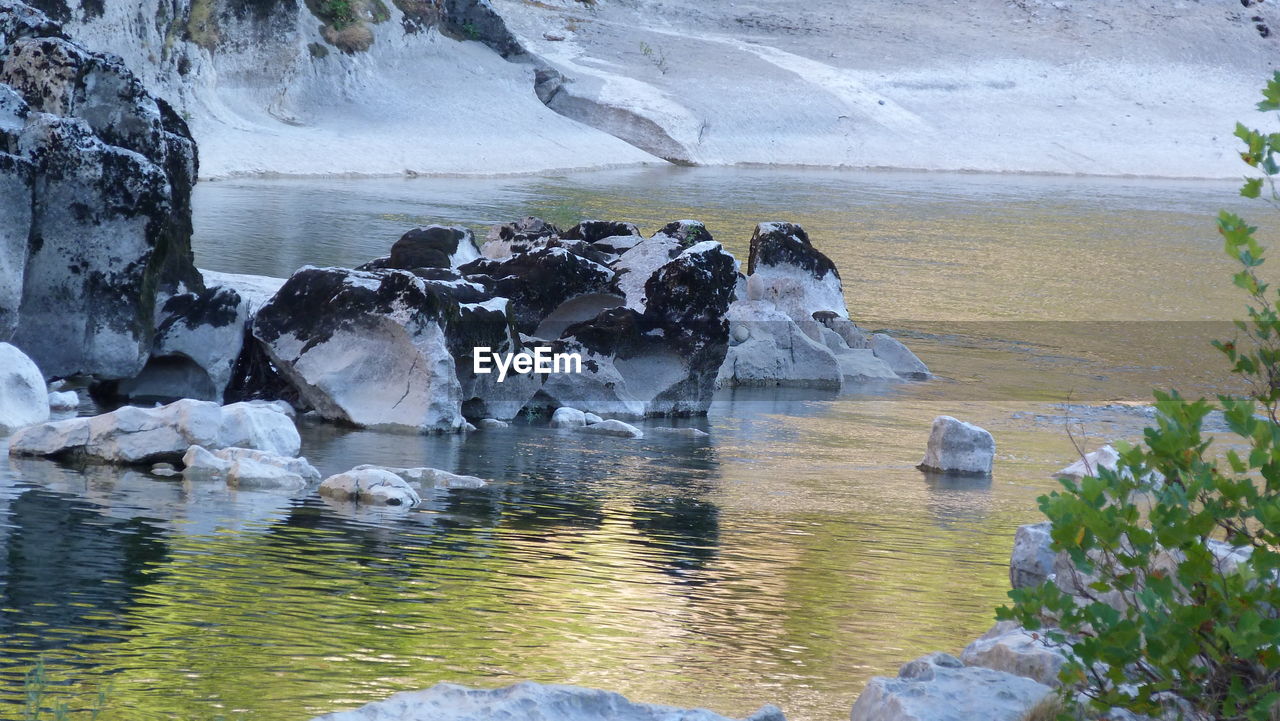 Scenic view of lake against rocks