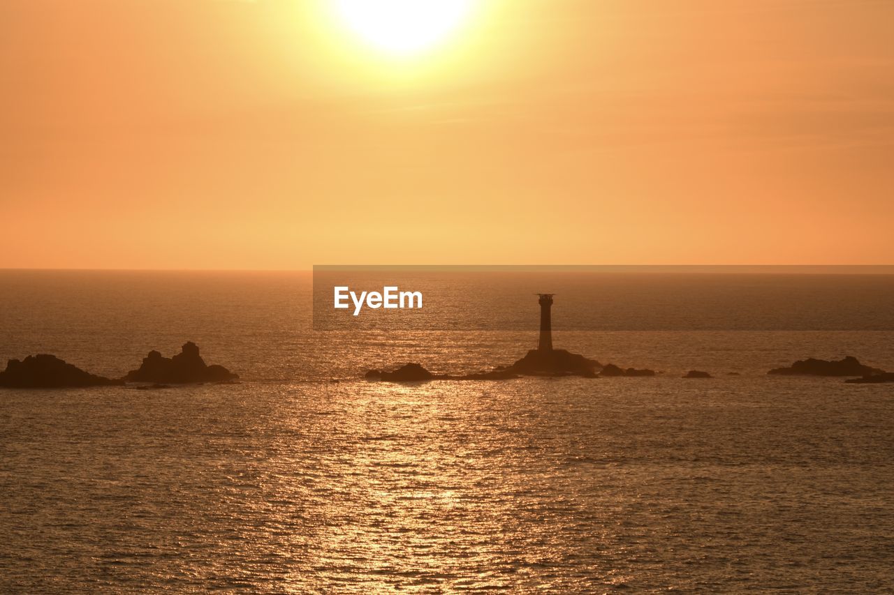 Lands end cornwall lighthouse at sunset