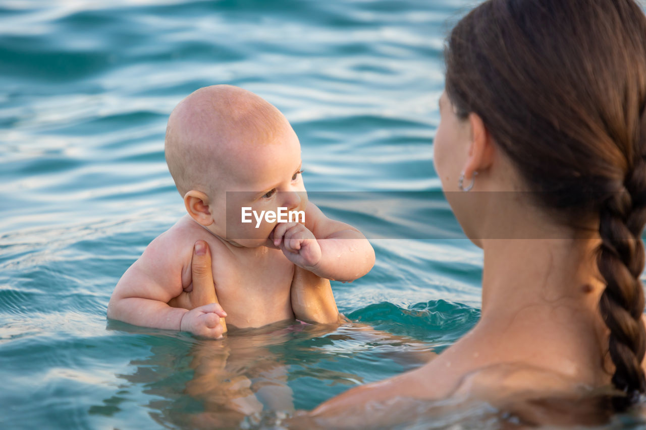 Mother and daughter in swimming pool