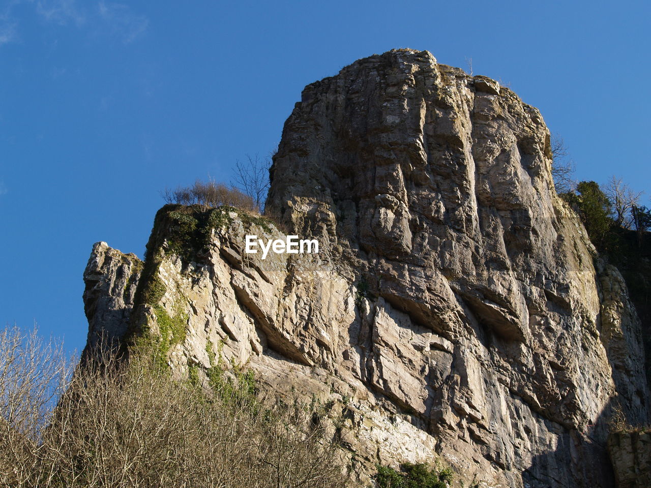 Low angle view of rock formation against clear sky