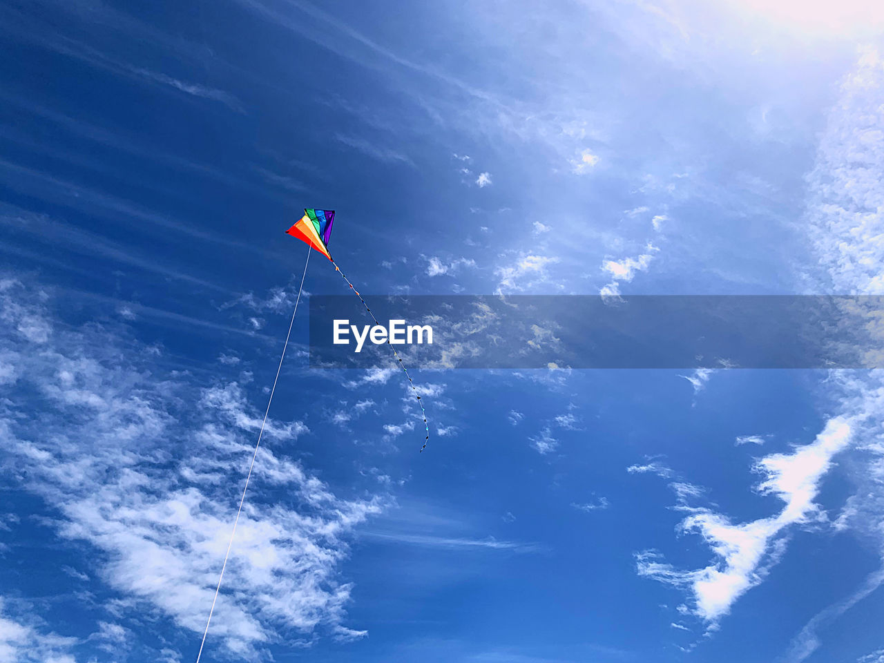 Low angle view of kite flying against blue sky