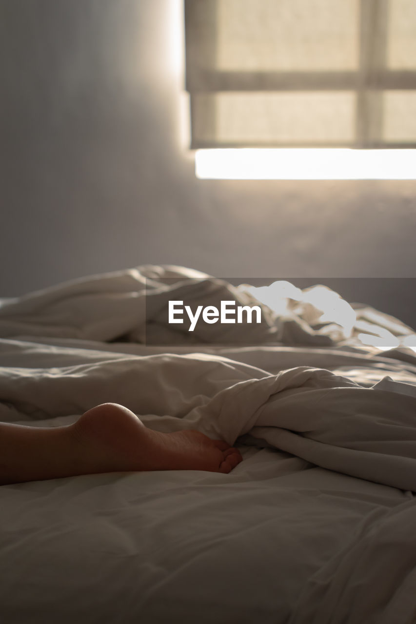 Person sleeping on bed at home