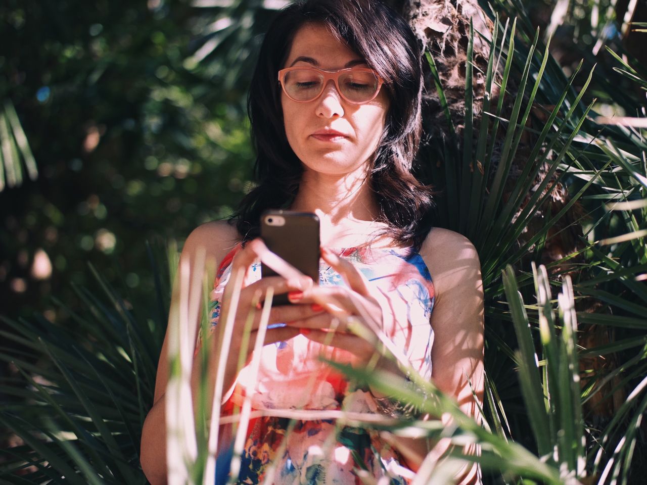 Young woman using mobile phone outdoors