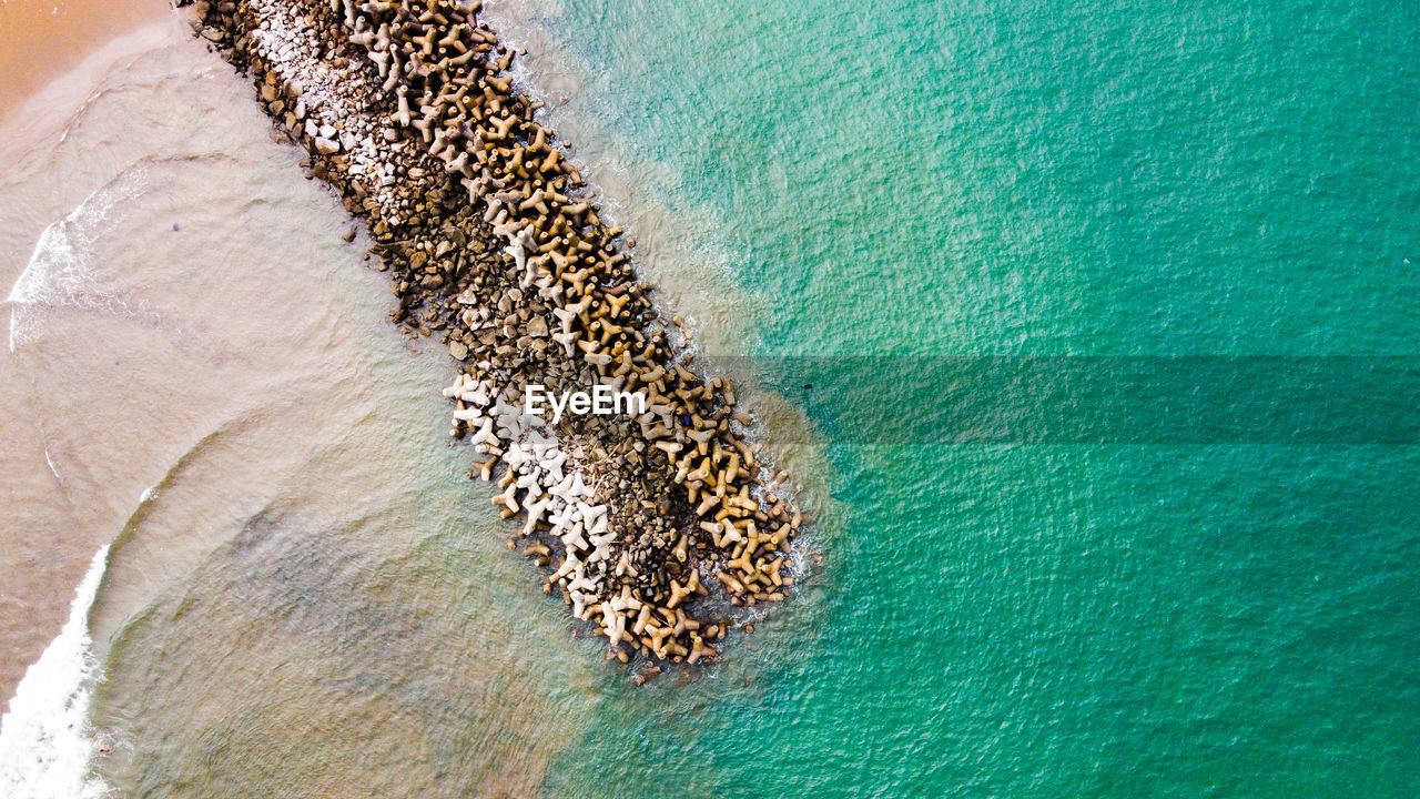 Aerial view of tetrapods in sea