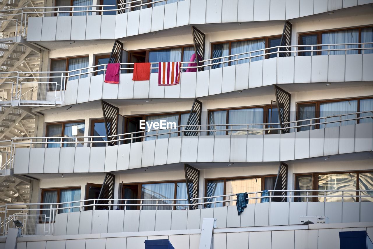 LOW ANGLE VIEW OF FLAG AGAINST BUILDINGS