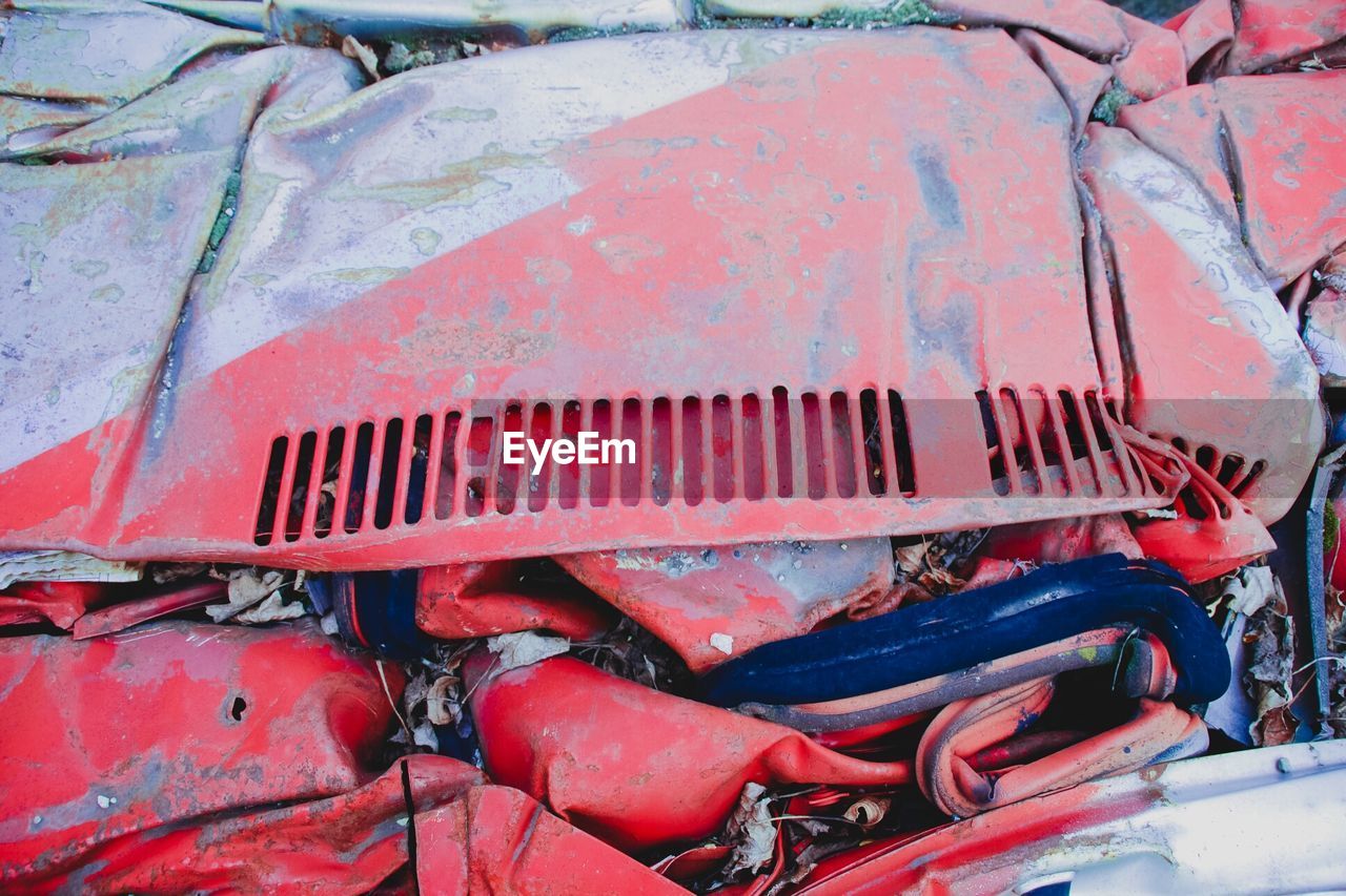 Full frame shot of damaged red car 