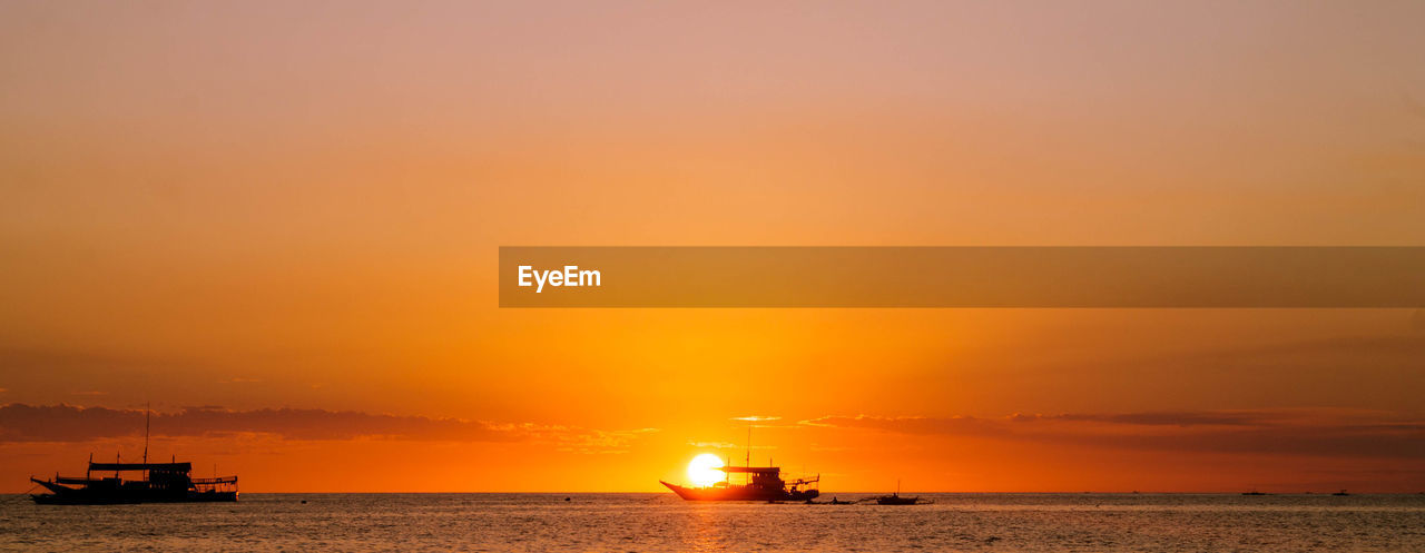 Scenic view of sea against orange sky