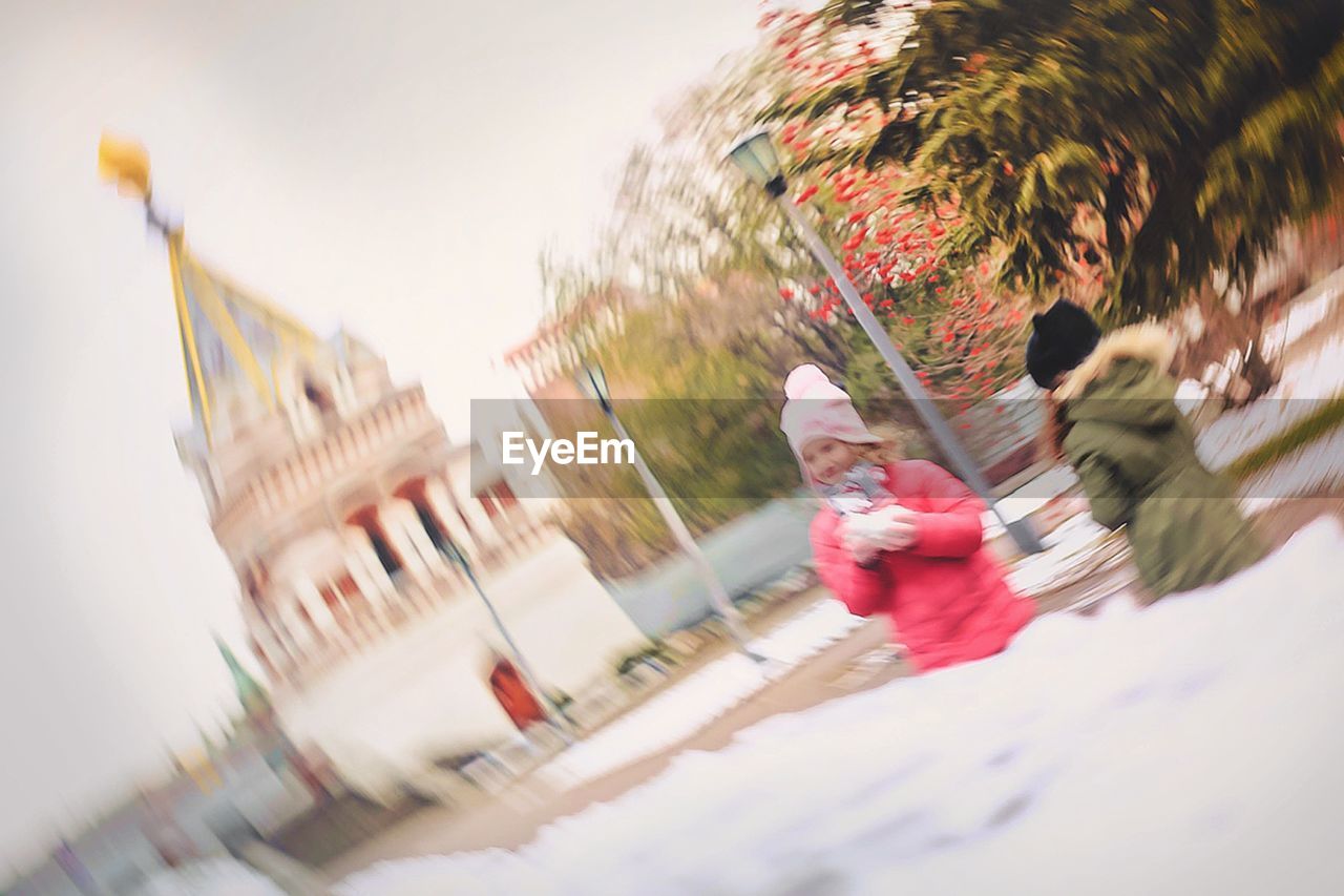 BLURRED MOTION OF BOY AGAINST TREE