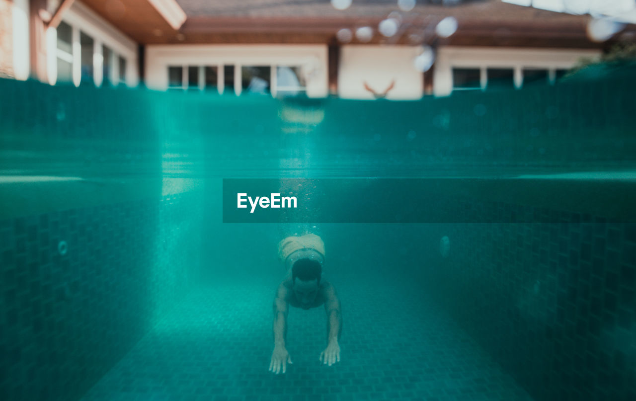 MAN SWIMMING IN POOL