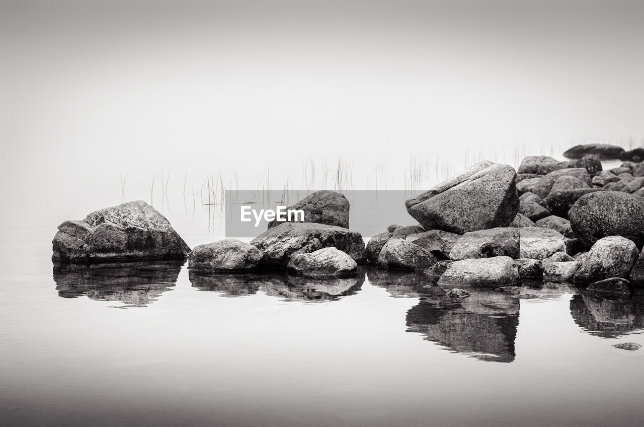 Rocks on water at lake in acadia national park