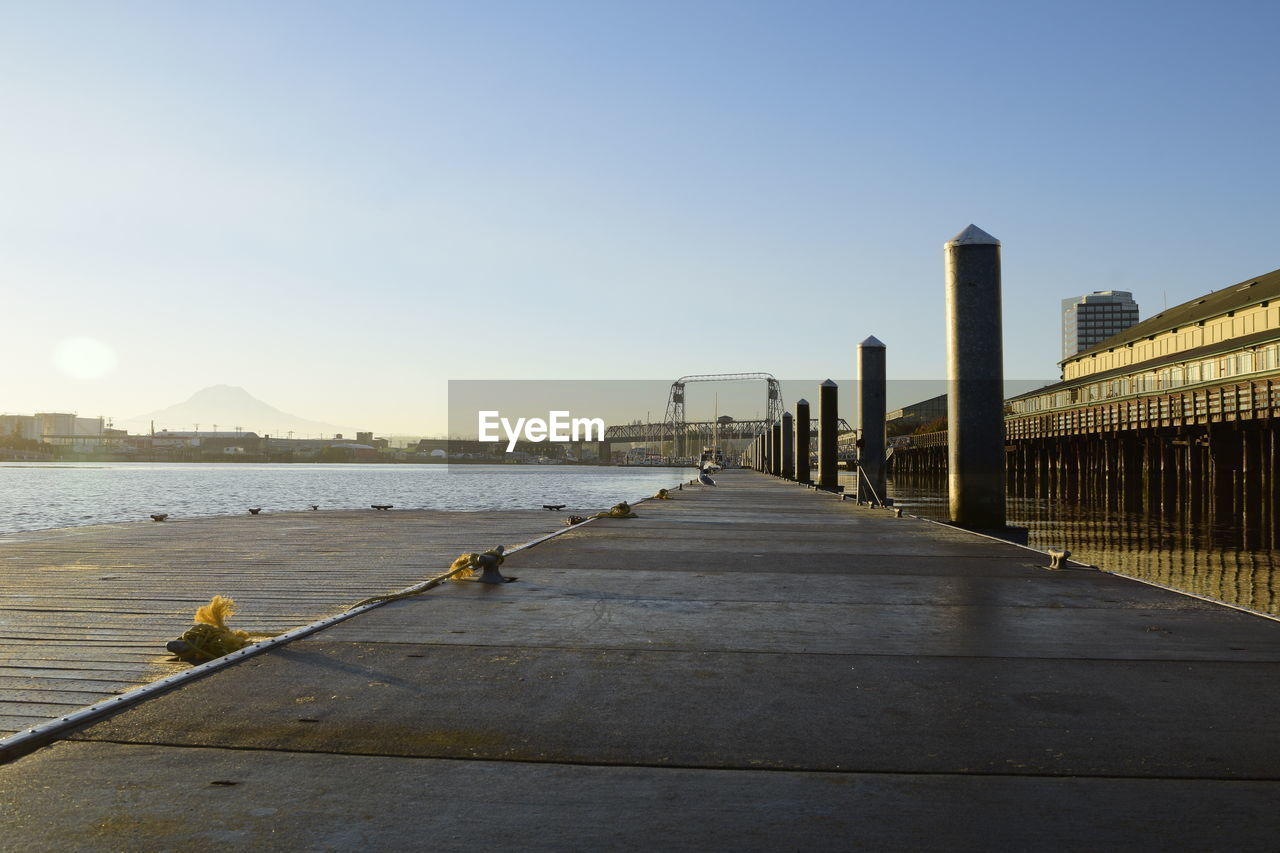 View of bridge and buildings against clear sky