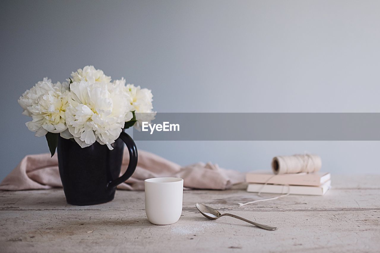 Close-up of flowers in mug on table