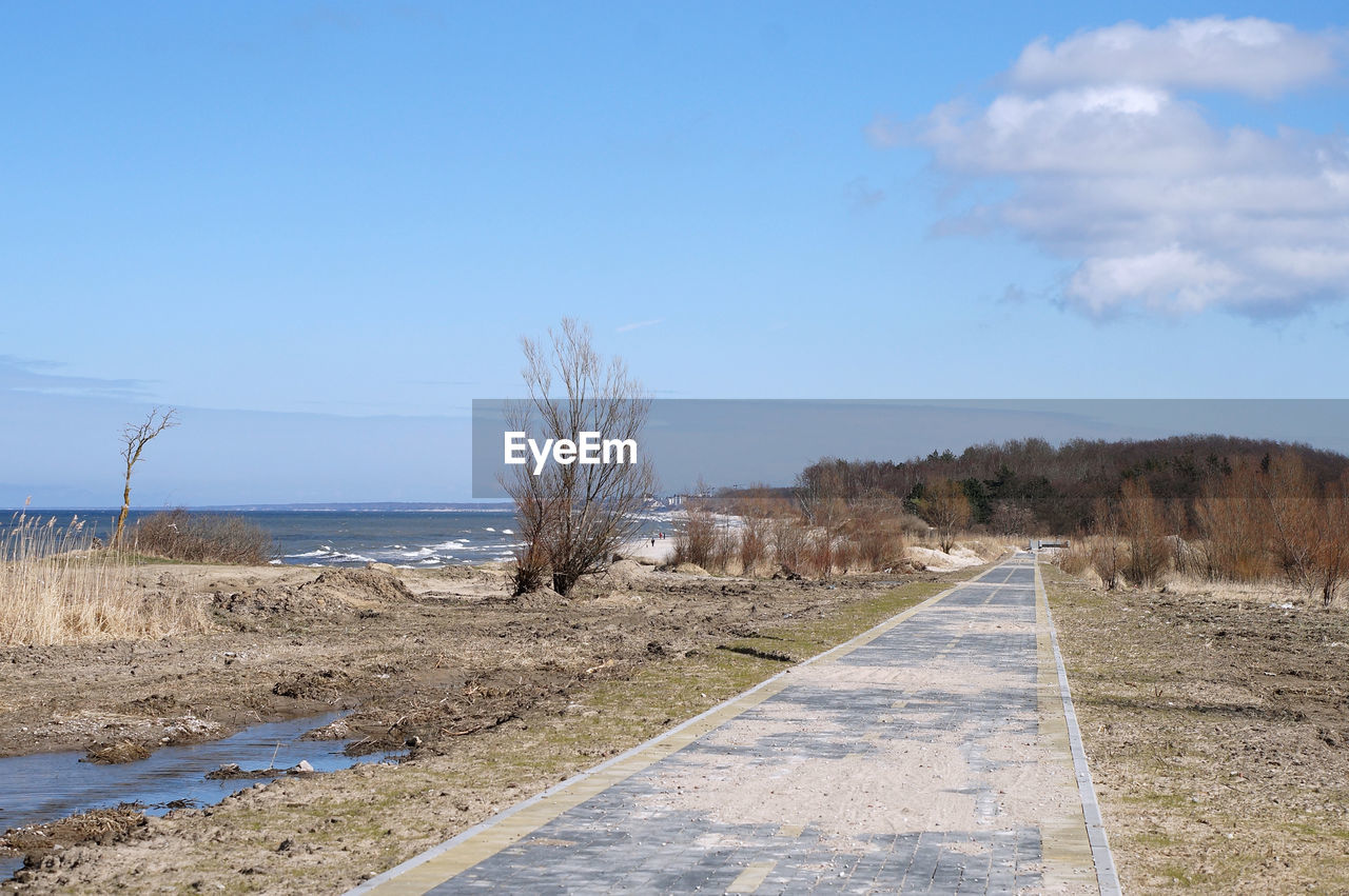 sky, nature, road, landscape, coast, sea, blue, plant, scenics - nature, no people, land, shore, day, environment, water, cloud, tranquility, tree, tranquil scene, the way forward, rural area, transportation, non-urban scene, beauty in nature, hill, outdoors, horizon, clear sky, sand, footpath, remote, natural environment, travel, sunlight, sunny, beach