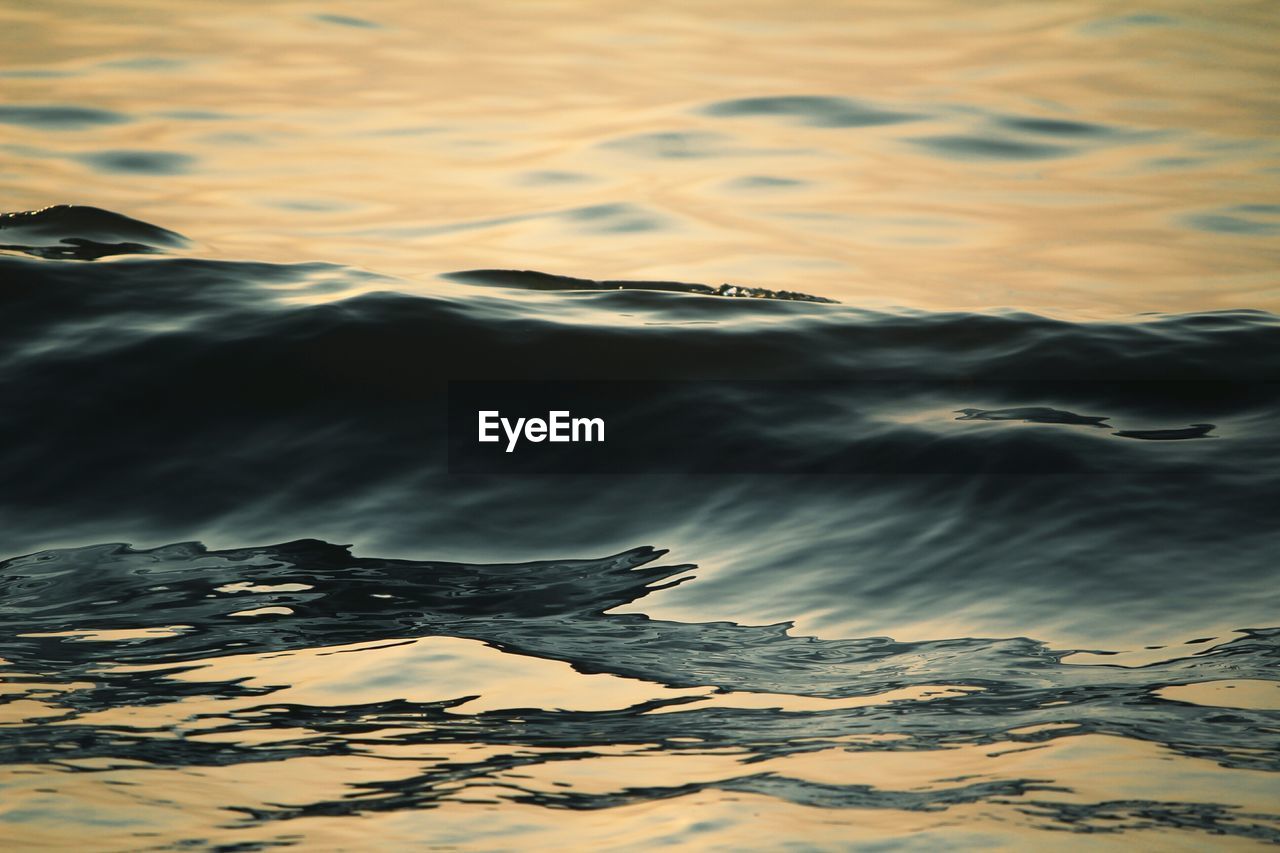 CLOSE-UP OF RIPPLED WATER AGAINST SKY