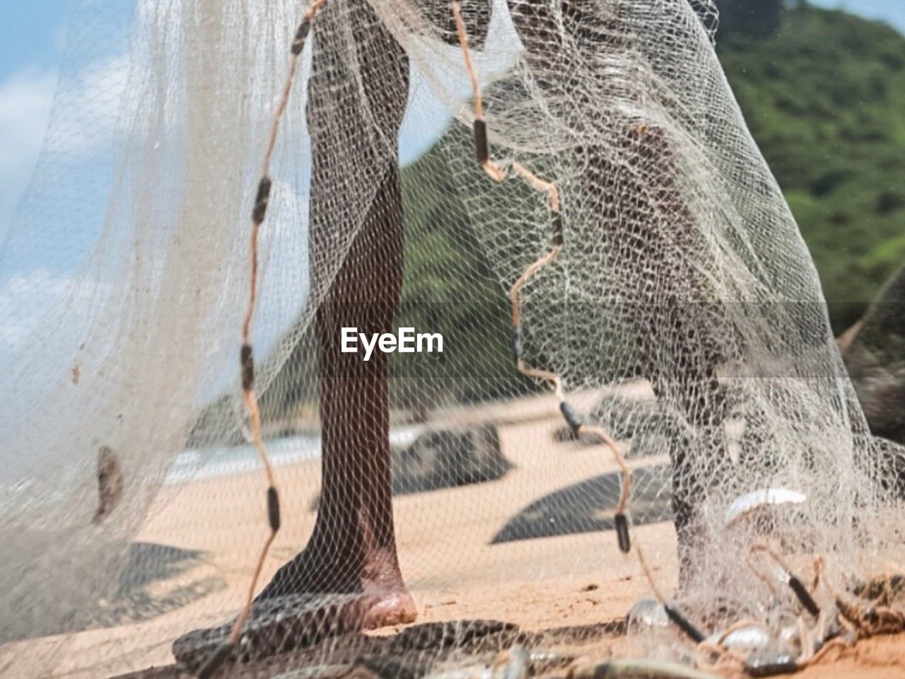 low angle view of fishing net against sky