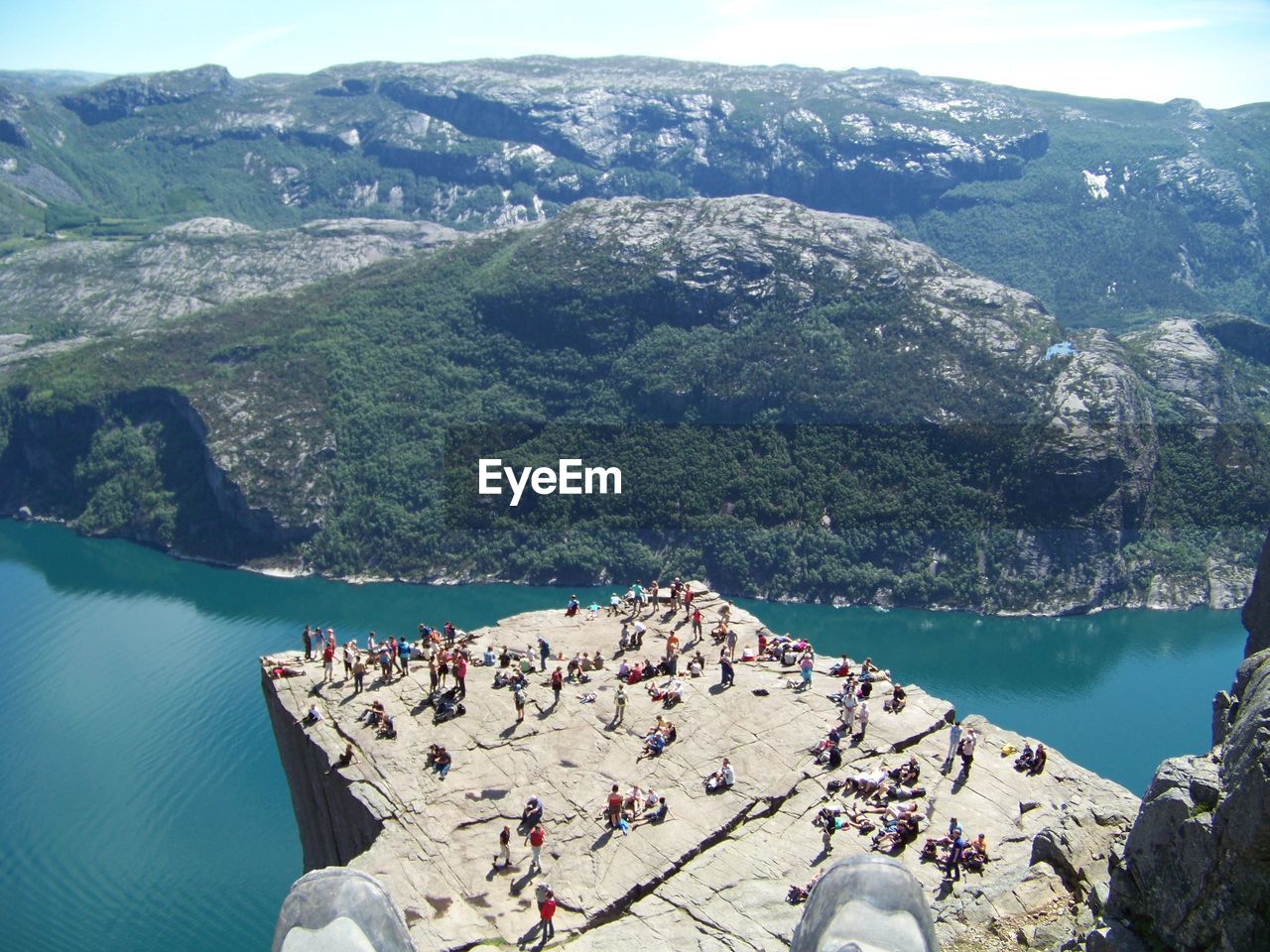 High angle view of rocks by sea against mountains