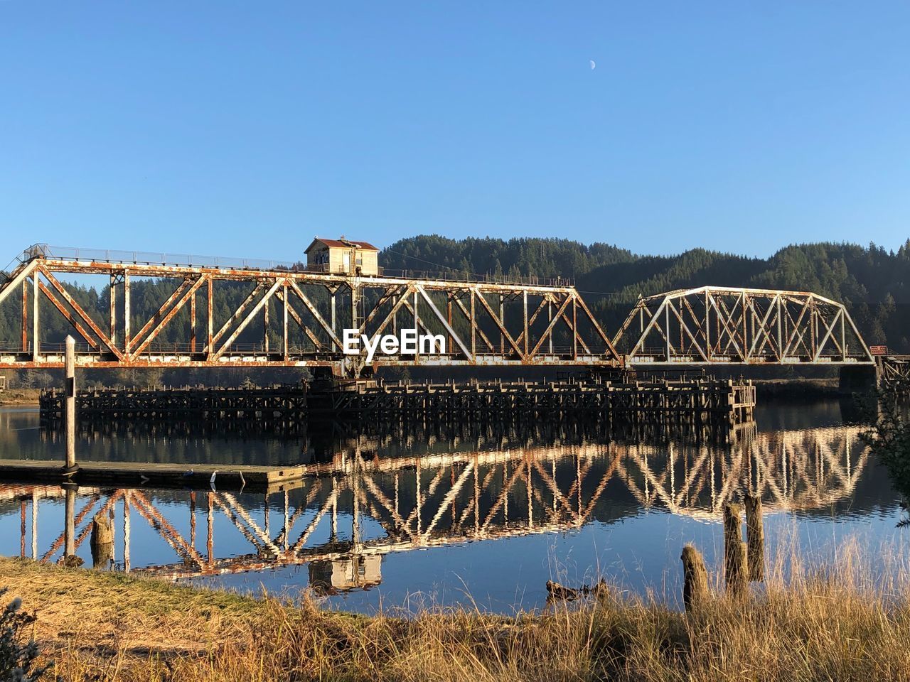 BRIDGE OVER RIVER AGAINST BLUE SKY