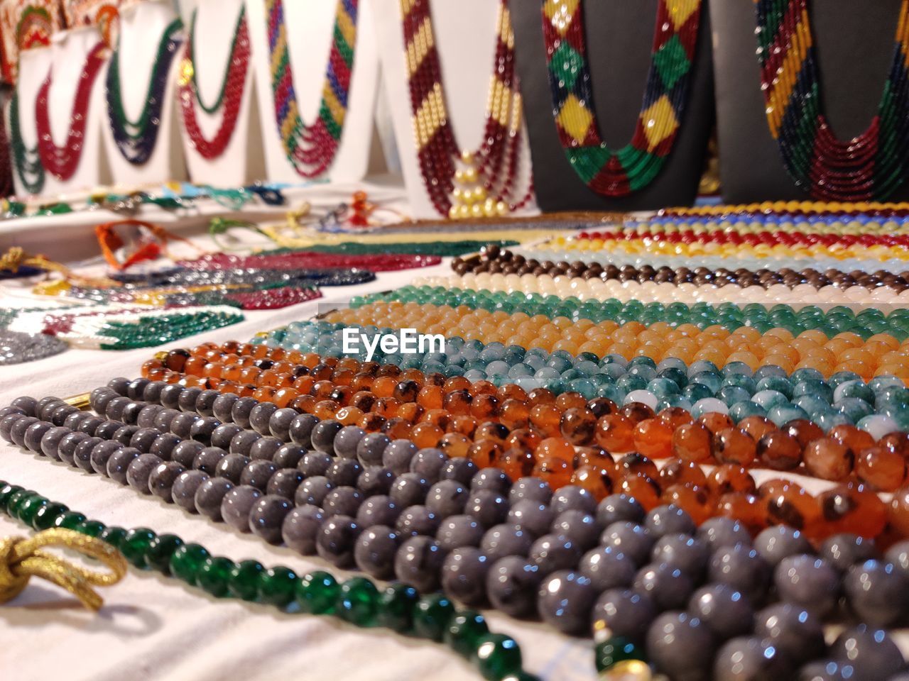 Close-up of multi colored necklace and decorative items for sale in market