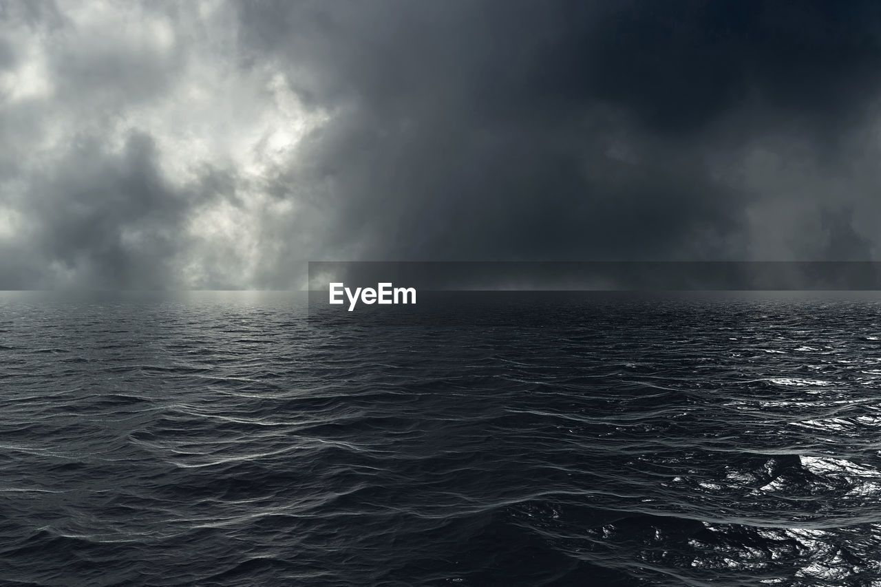 SCENIC VIEW OF SEA AGAINST STORM CLOUDS IN SKY