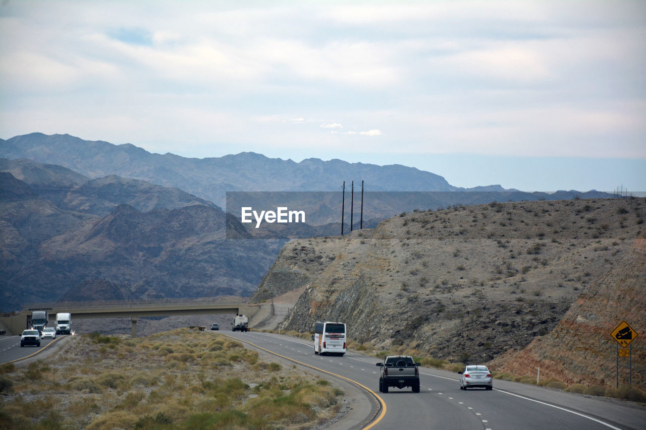 CAR ON MOUNTAIN AGAINST SKY