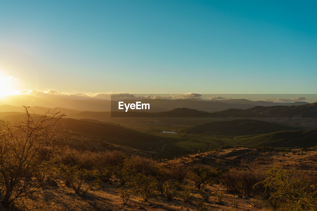 Scenic view of landscape against sky during sunset