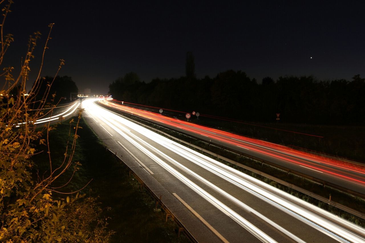 High angle view of light trails on country road at night