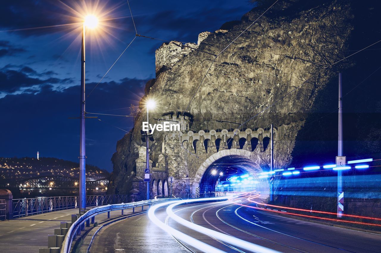 light trails on road against sky