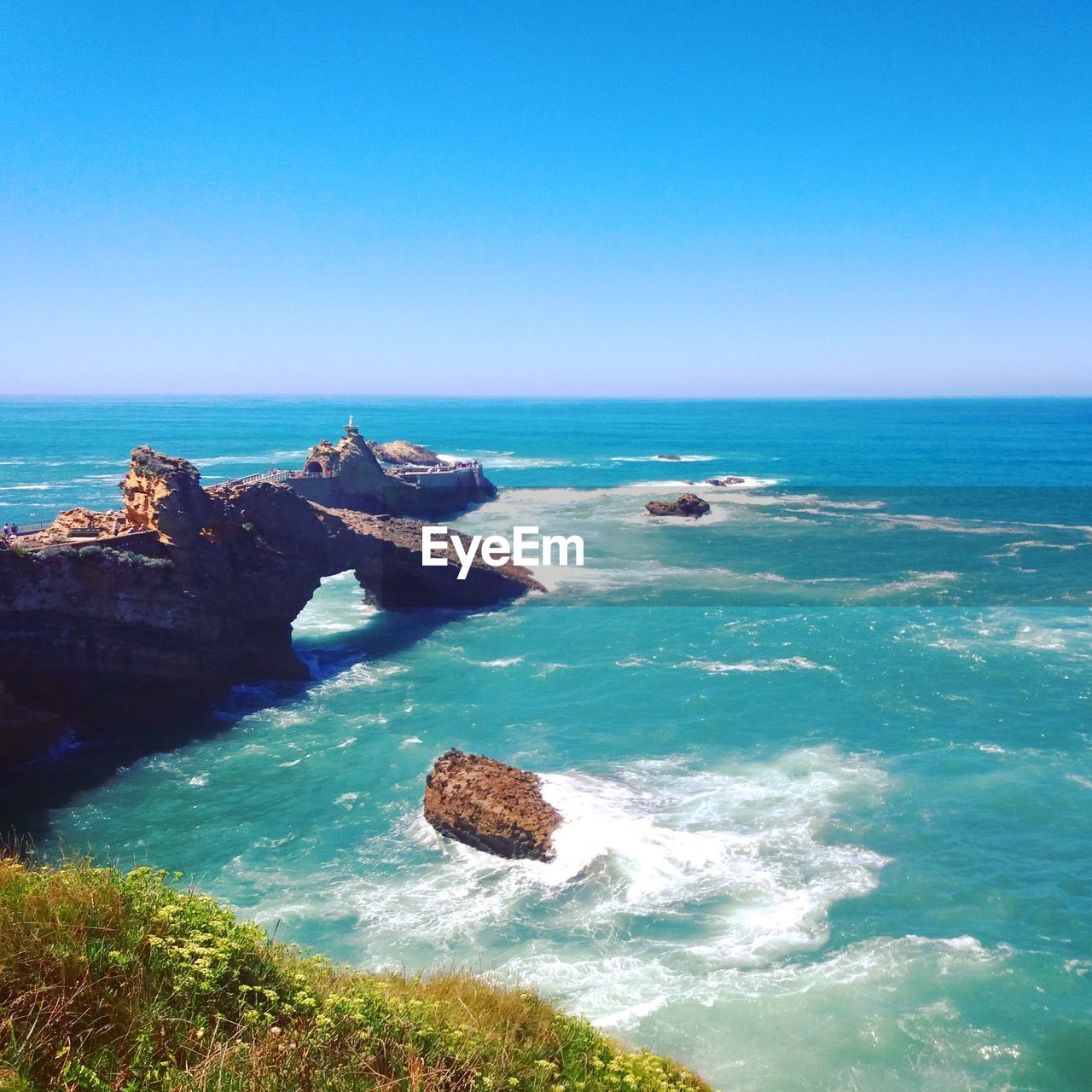 Scenic view of sea against clear blue sky