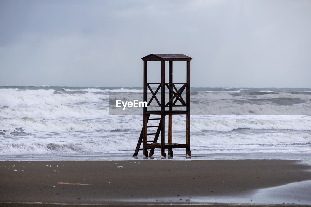 pier on beach against sky