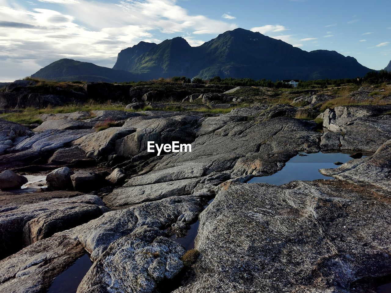 mountain, wilderness, environment, sky, landscape, rock, scenics - nature, beauty in nature, nature, cloud, land, mountain range, water, travel destinations, no people, sea, travel, coast, geology, ridge, outdoors, non-urban scene, tranquility, volcano, tranquil scene, day, terrain, blue