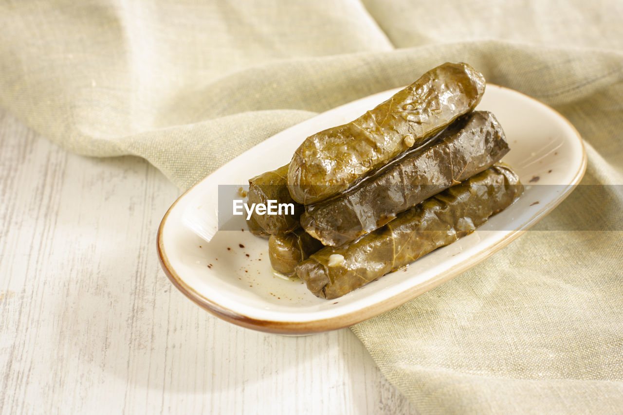 Traditional turkish meal - yaprak dolma. stuffed grape leaves with olive oil and fresh lemon