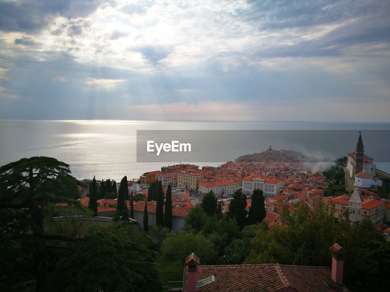 Scenic view of sea by buildings against sky