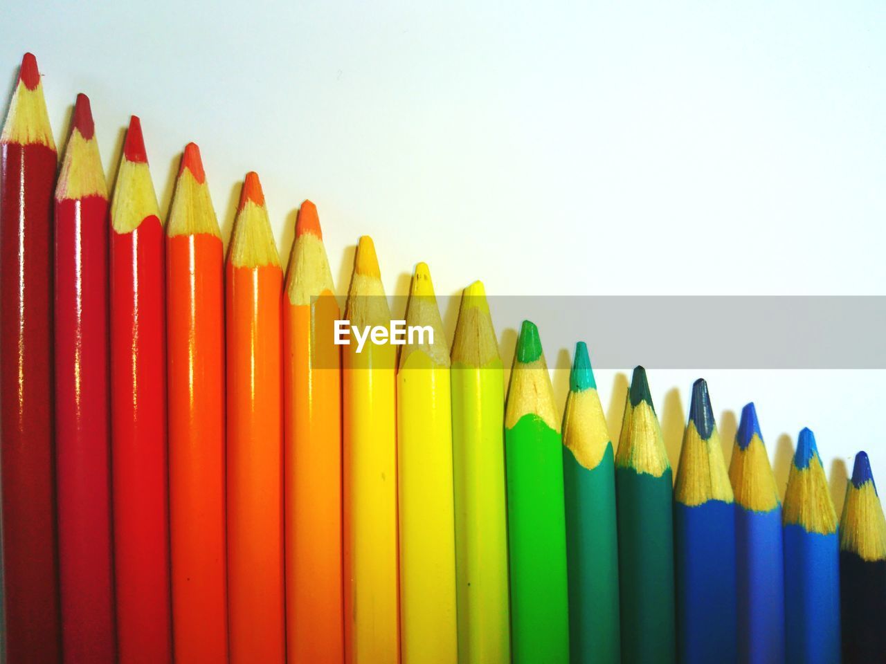 Close-up of colored pencils against white background