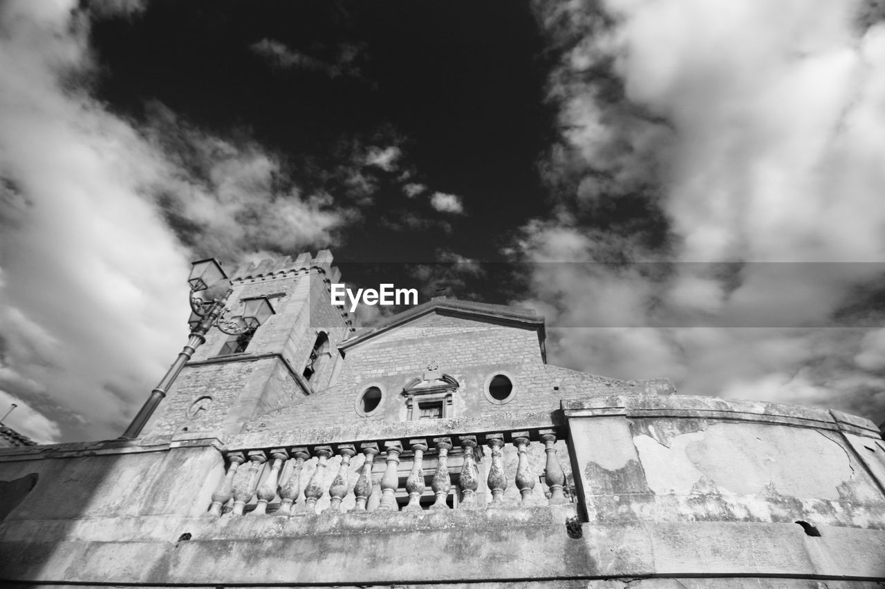 Low angle view of historic building against cloudy sky