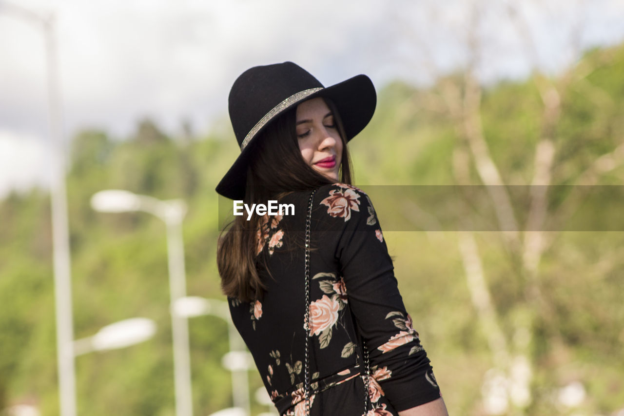 Young woman with eyes closed standing outdoors