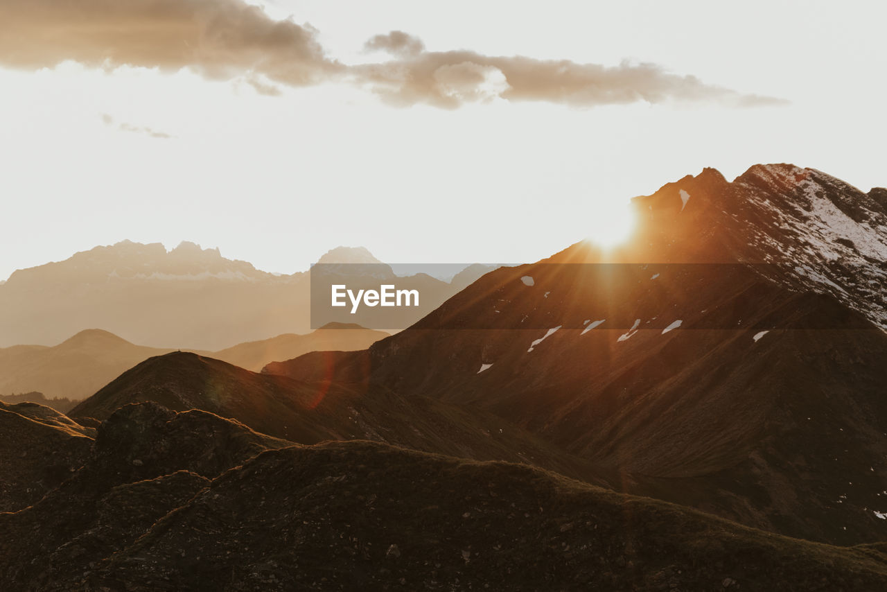 Scenic view of mountains against sky during sunset