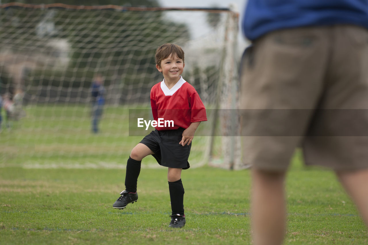 Young boy with big smile on a soccer field