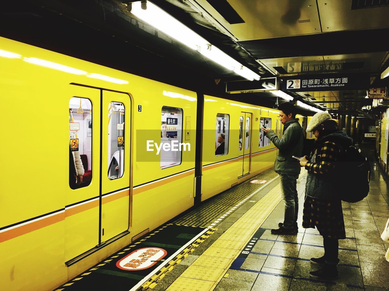 TRAIN ON SUBWAY STATION PLATFORM