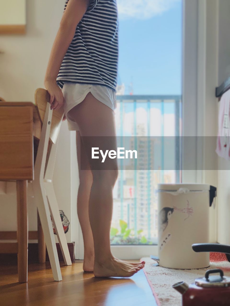 LOW SECTION OF WOMAN STANDING ON TABLE