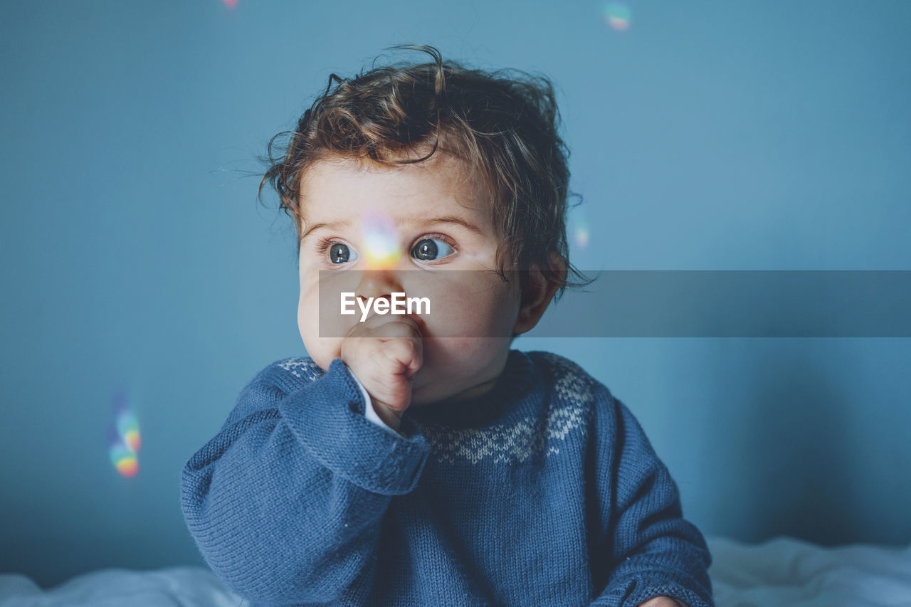 Cute baby girl on bed at home