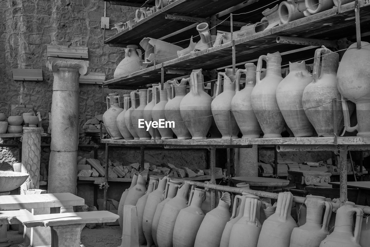 Vases on shelves in workshop