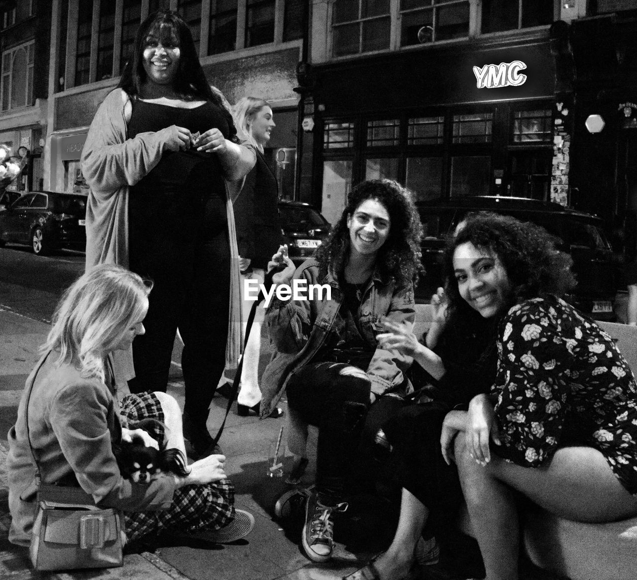 GROUP OF PEOPLE SITTING IN PARK