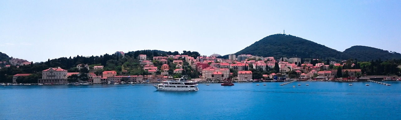 Panoramic view of sea and mountains against clear sky