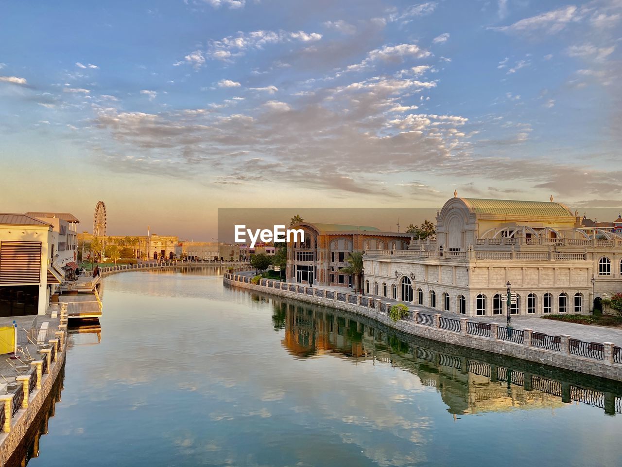 Reflection of buildings in lake at sunset