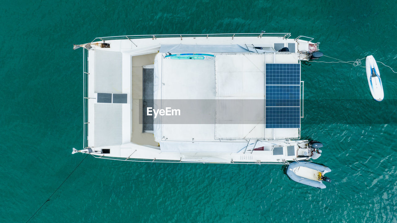 water, nautical vessel, transportation, vehicle, sea, mode of transportation, boat, ship, catamaran, high angle view, watercraft, passenger ship, nature, travel, aerial view, yacht, sailboat, no people, luxury, day, sailing, vacation, directly above, outdoors, holiday, luxury yacht, turquoise colored, trip