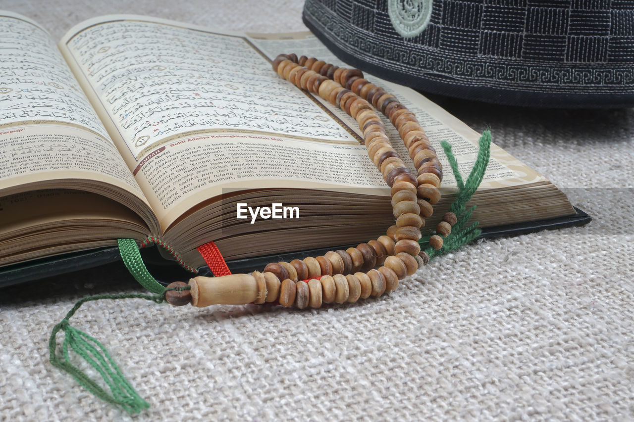 CLOSE-UP OF BOOK ON TABLE