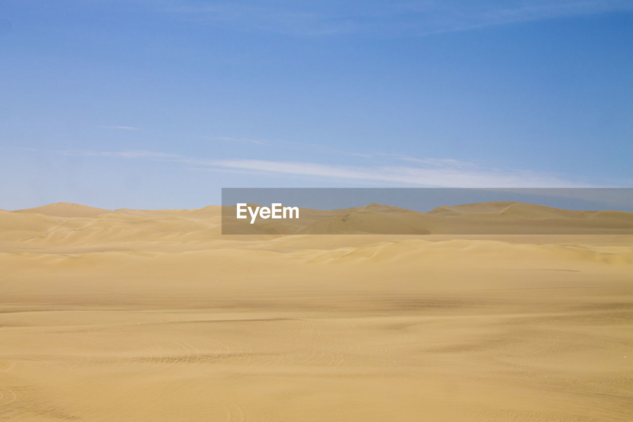 SCENIC VIEW OF SAND DUNE AGAINST SKY