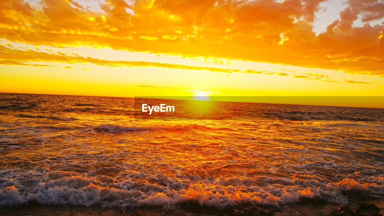 SCENIC VIEW OF SUNSET OVER SEA