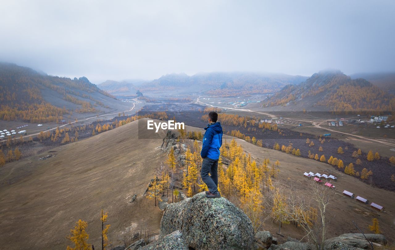 MAN WORKING ON MOUNTAIN