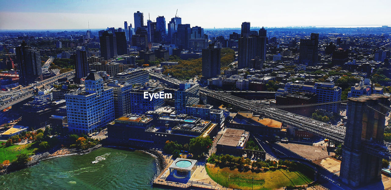 HIGH ANGLE VIEW OF RIVER AND BUILDINGS AGAINST SKY